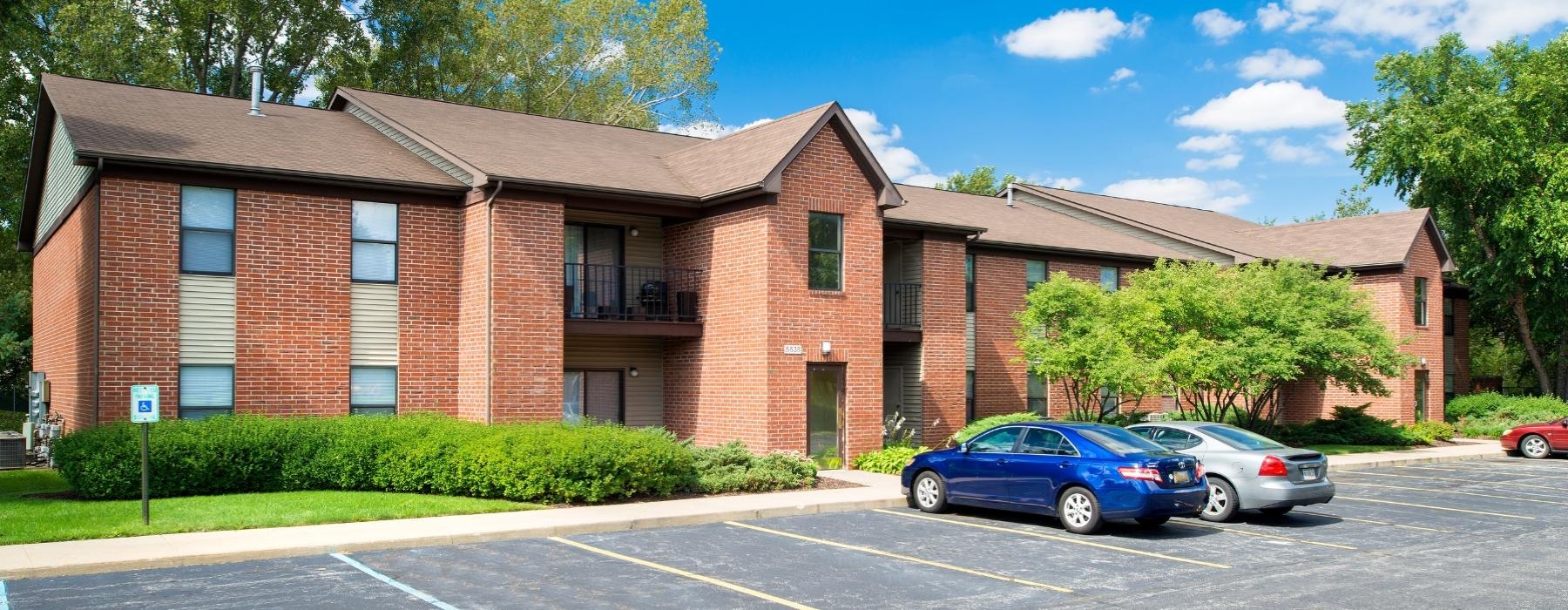 a brick building with cars parked in front of it