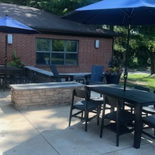 a patio with umbrellas over tables
